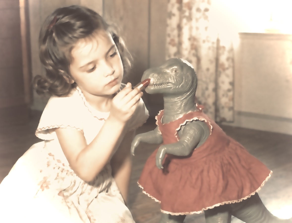 A faded 1950s photo: a girl putting lipstick on the cheap toy dinosaur she was given, which she has dressed in a red doll's dress
